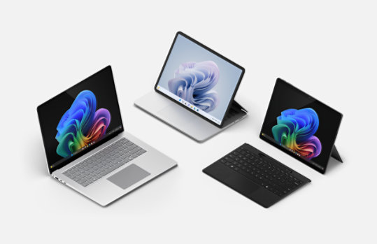 A Surface Laptop, Surface Laptop Studio 2, and Surface Pro with a black Flex keyboard.