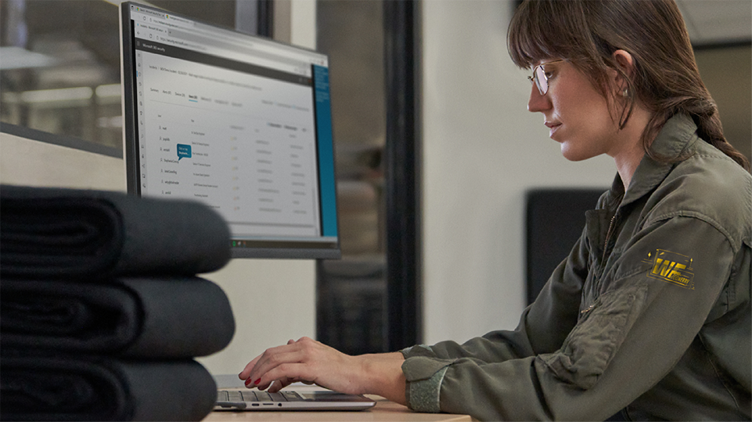 A female sitting at a desk working on a computer