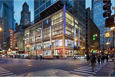 A Walgreens lit up at night in a major city 