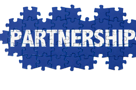 Partnership spelt out in white letters on blue jigsaw pieces